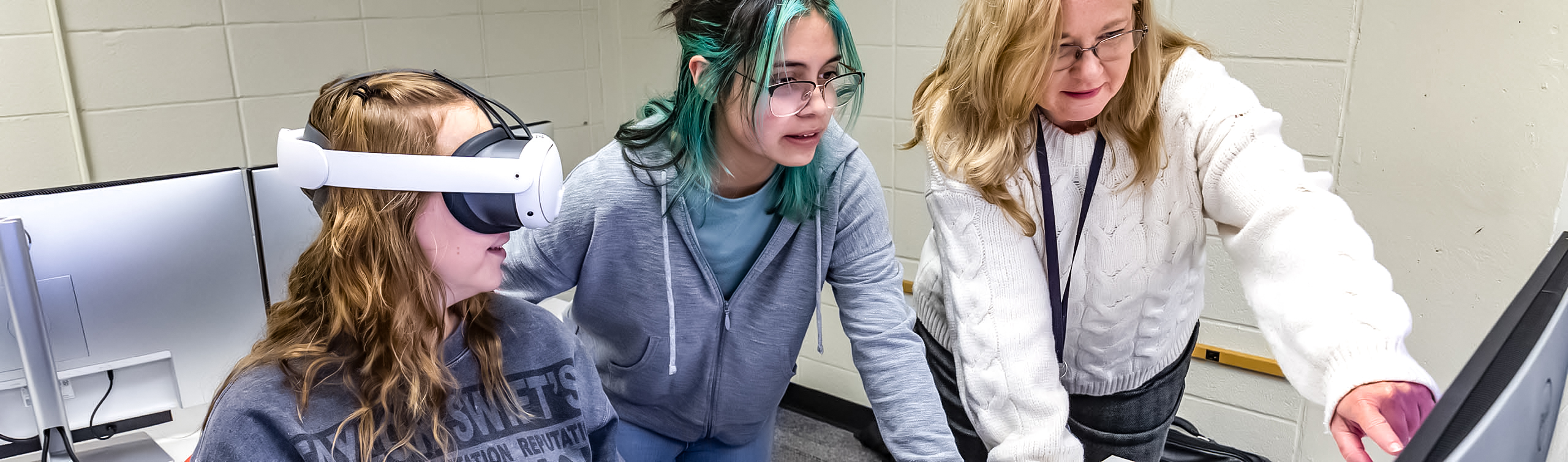 Students and a faculty member using virtual reality in a CADD class