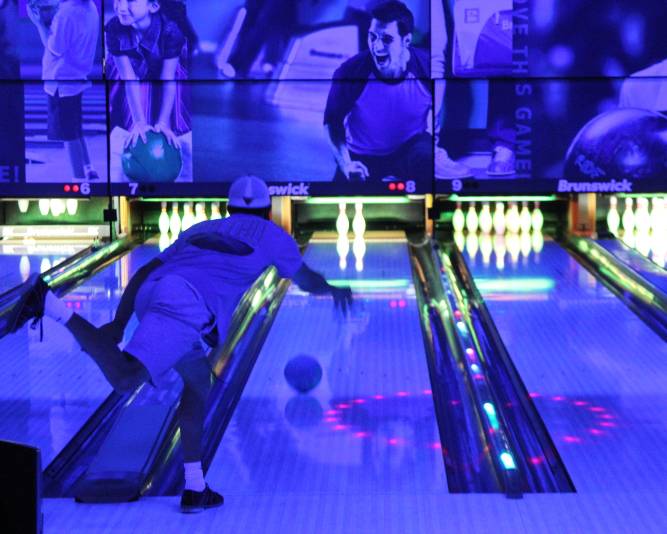 A person glow bowling at the Elliot Student Union