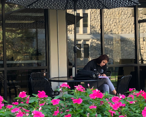 A student relaxing outside the student union