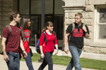 four students walking on campus talking
