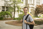 male student wearing backpack on campus