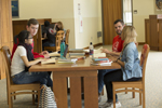 students sitting at table in the library