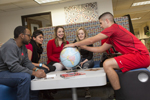 group of students looking at globe