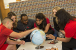 students looking at globe